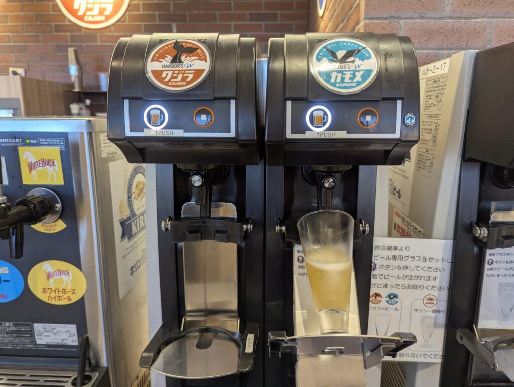 HARBOR'S Wクラフトビール・クジラとカモメの自動サーバー、右は注がれている途中のグラス